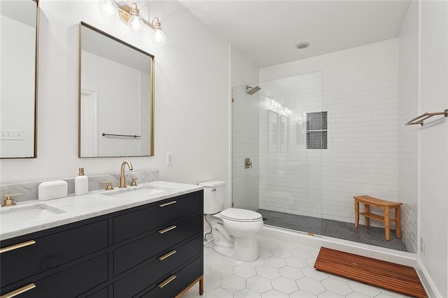 full bath with tile patterned flooring, a sink, and tiled shower