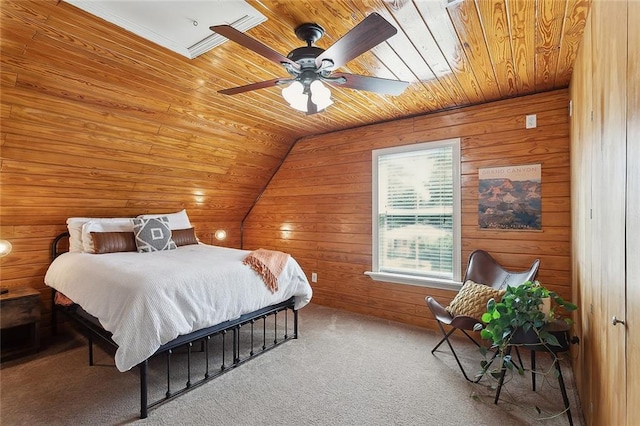 carpeted bedroom with wooden walls, ceiling fan, vaulted ceiling, and wooden ceiling
