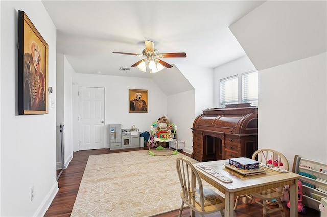playroom with baseboards, visible vents, ceiling fan, and dark wood finished floors