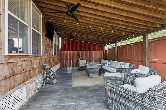 wooden terrace with a fenced backyard and outdoor lounge area