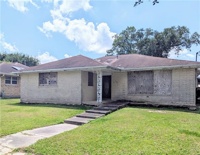 ranch-style house with brick siding and a front yard