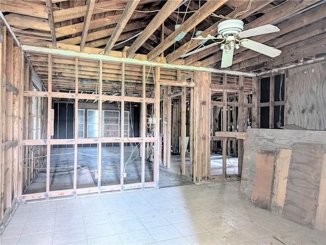 basement featuring tile patterned flooring and ceiling fan