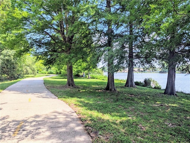 surrounding community featuring a water view and a yard
