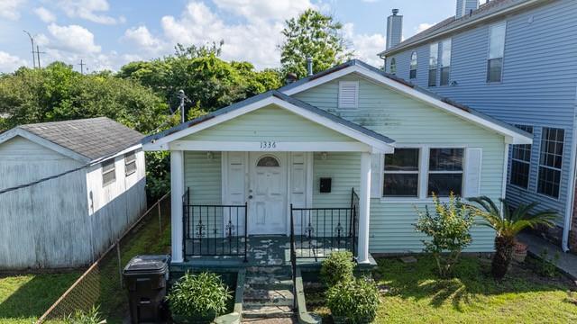 1336 Sere St, New Orleans, LA 70122 - view of front of home featuring an outbuilding, covered porch, and a shed