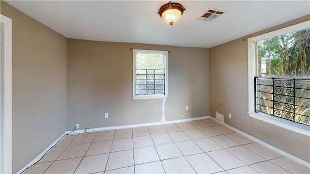 1336 Sere St, New Orleans, LA 70122 - empty room with visible vents, baseboards, light tile patterned floors, and a wealth of natural light