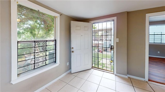 1336 Sere St, New Orleans, LA 70122 - entryway with light tile patterned floors, baseboards, and a wealth of natural light
