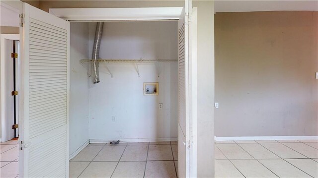 1336 Sere St, New Orleans, LA 70122 - clothes washing area with light tile patterned floors, washer hookup, baseboards, and laundry area
