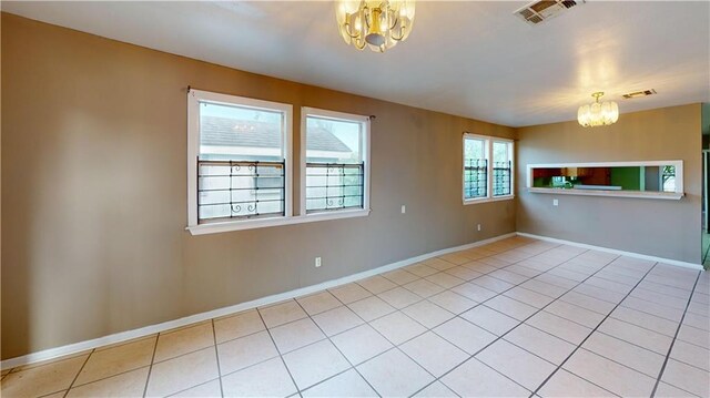 1336 Sere St, New Orleans, LA 70122 - interior space featuring baseboards, a chandelier, light tile patterned floors, and visible vents