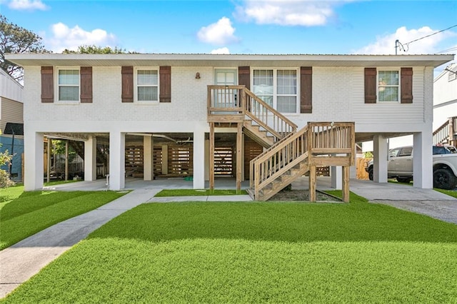 2967 Camellia Dr, Slidell, LA 70458 - rear view of property with stairs, brick siding, concrete driveway, a carport, and a yard