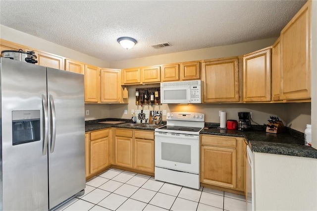 2967 Camellia Dr, Slidell, LA 70458 - kitchen featuring visible vents, light brown cabinetry, dark countertops, white appliances, and a sink