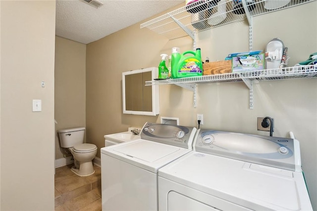 2967 Camellia Dr, Slidell, LA 70458 - laundry area featuring laundry area, washing machine and dryer, a sink, tile patterned floors, and baseboards