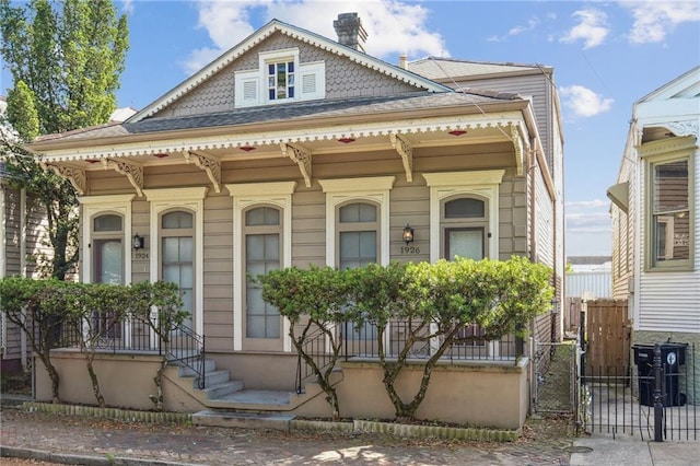 192426 Esplanade Ave, New Orleans, LA 70116 - view of front of home featuring fence and a chimney