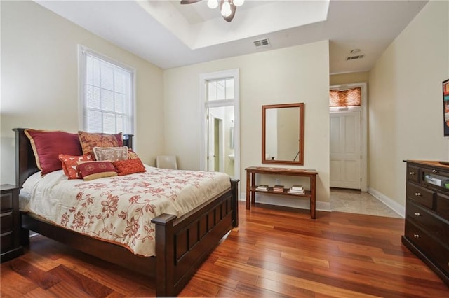 192426 Esplanade Ave, New Orleans, LA 70116 - bedroom with wood-type flooring, baseboards, visible vents, and a raised ceiling