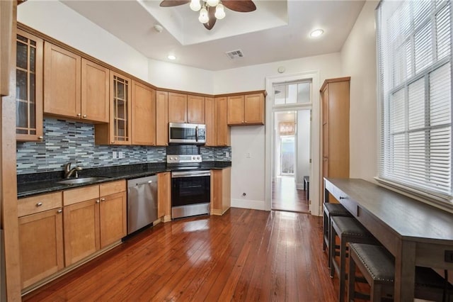 192426 Esplanade Ave, New Orleans, LA 70116 - kitchen featuring a tray ceiling, visible vents, tasteful backsplash, a sink, and stainless steel appliances