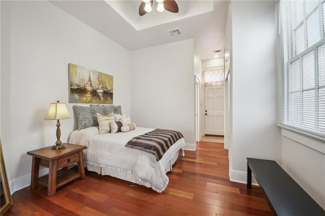192426 Esplanade Ave, New Orleans, LA 70116 - bedroom featuring visible vents, a raised ceiling, wood finished floors, and multiple windows