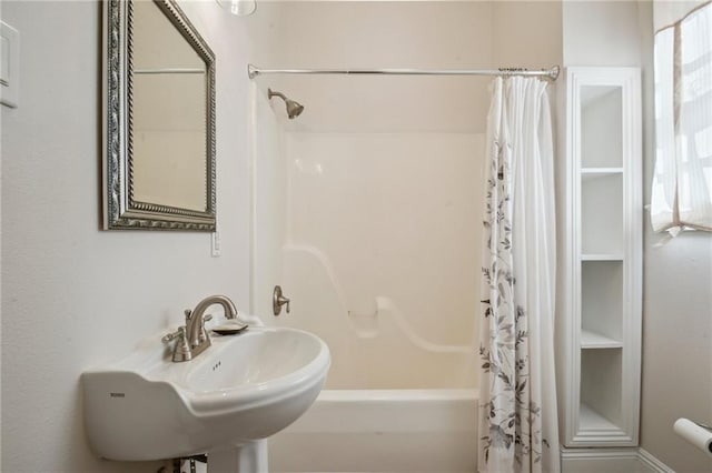 192426 Esplanade Ave, New Orleans, LA 70116 - bathroom with a sink and shower / bath combo with shower curtain