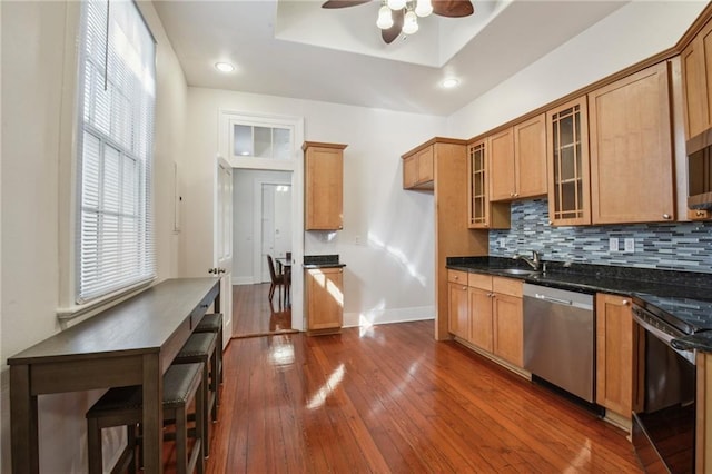 192426 Esplanade Ave, New Orleans, LA 70116 - kitchen with stainless steel dishwasher, baseboards, range with electric stovetop, ceiling fan, and dark wood-style floors