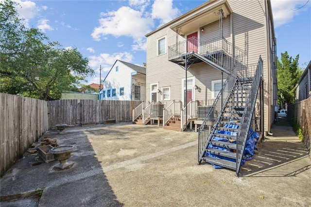 192426 Esplanade Ave, New Orleans, LA 70116 - rear view of property featuring stairway, a fenced backyard, and a balcony