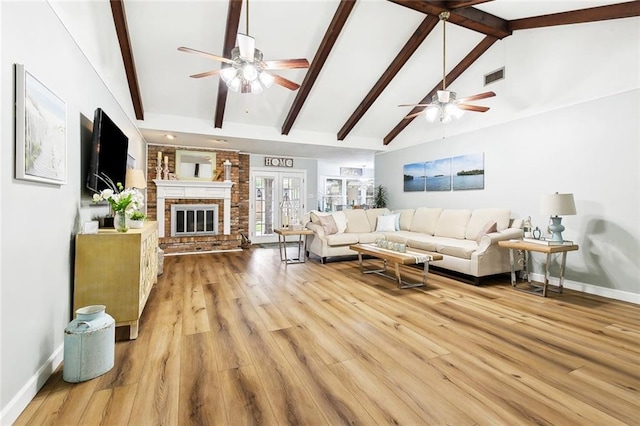 living room featuring a ceiling fan, baseboards, and visible vents