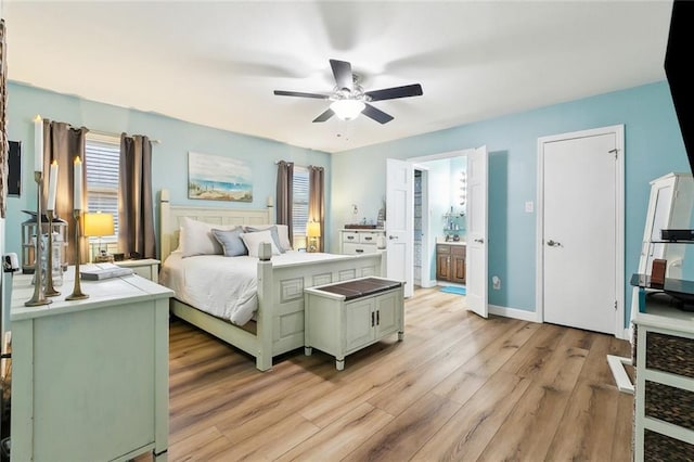 bedroom with light wood-style floors, connected bathroom, and baseboards