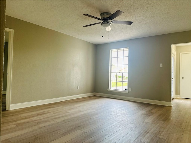 unfurnished room featuring a ceiling fan, a textured ceiling, and wood finished floors