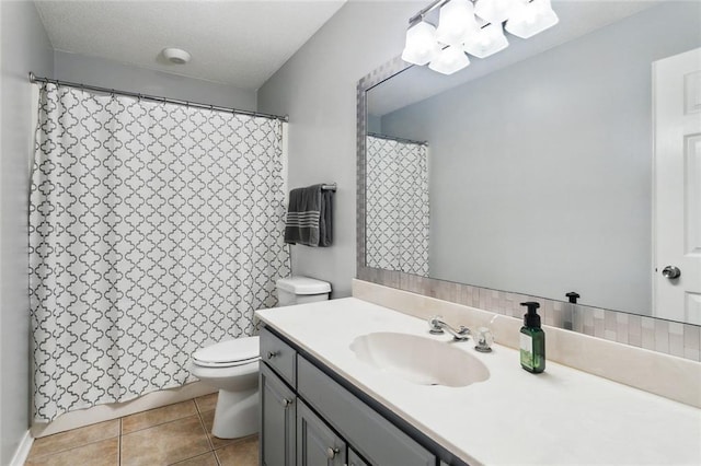 full bathroom with tile patterned flooring, vanity, curtained shower, toilet, and a chandelier