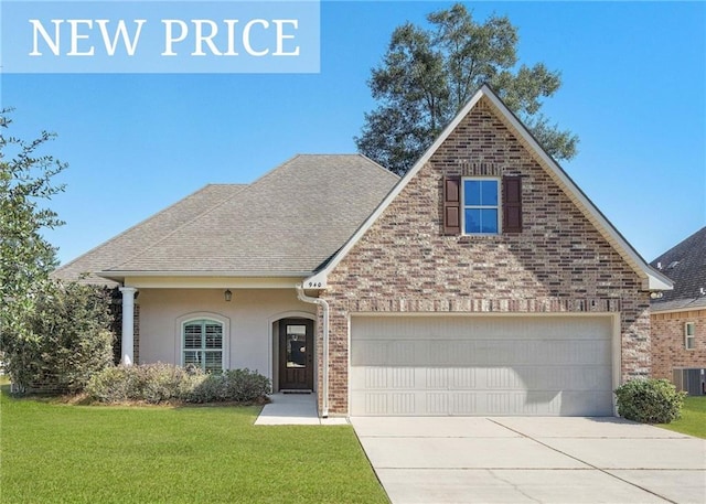 940 Woodsprings Ct, Covington, LA 70433 - view of front of house featuring driveway, a front lawn, central air condition unit, an attached garage, and roof with shingles