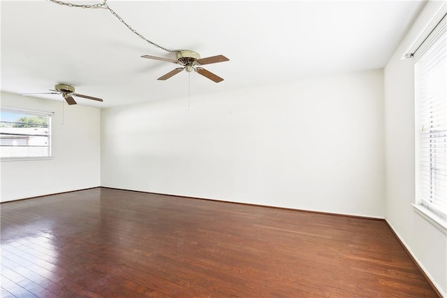 empty room with ceiling fan and wood finished floors