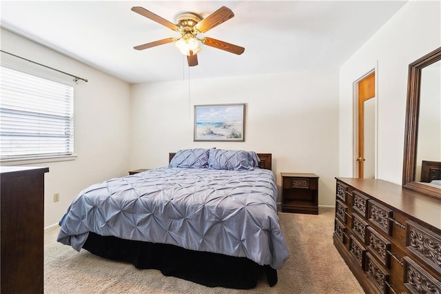 carpeted bedroom with baseboards and ceiling fan