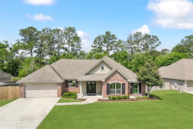 view of front of property featuring a garage, a front lawn, fence, brick siding, and driveway