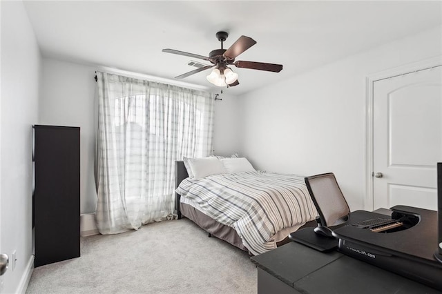carpeted bedroom with baseboards and ceiling fan