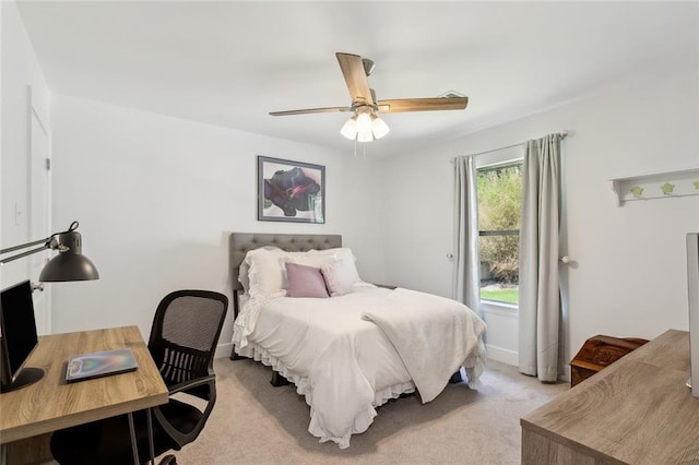 bedroom featuring baseboards, ceiling fan, and light carpet