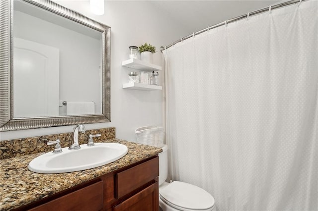 bathroom with vanity, a shower with curtain, and toilet