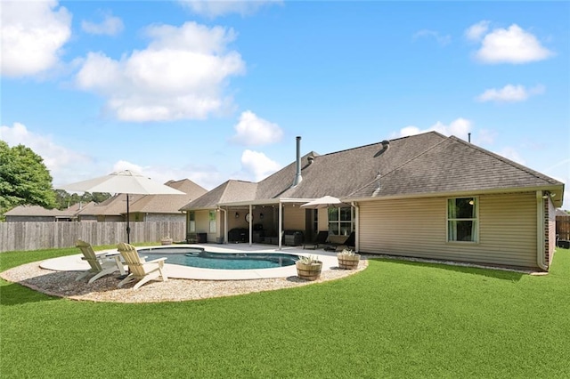 view of swimming pool with a lawn, fence, a patio area, and a fenced in pool