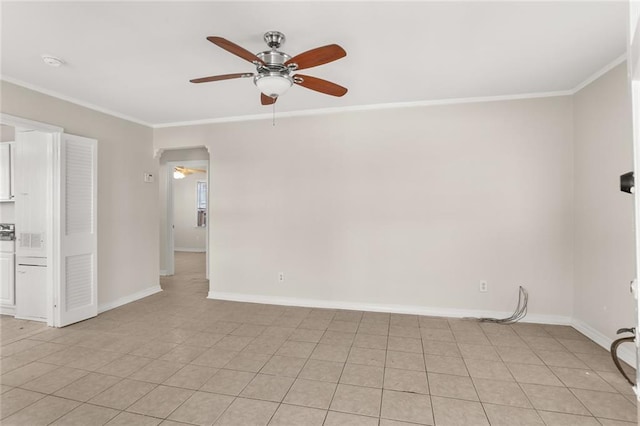 spare room featuring baseboards, ornamental molding, and ceiling fan