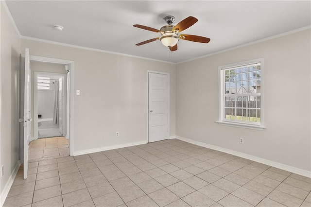 empty room with plenty of natural light, ornamental molding, light tile patterned flooring, and ceiling fan