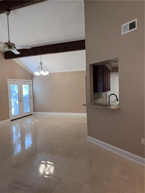 interior space with visible vents, beam ceiling, baseboards, high vaulted ceiling, and ceiling fan with notable chandelier
