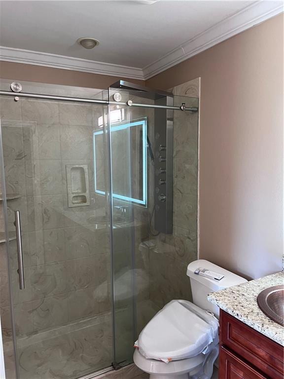 bathroom with vanity, ornamental molding, a stall shower, and toilet