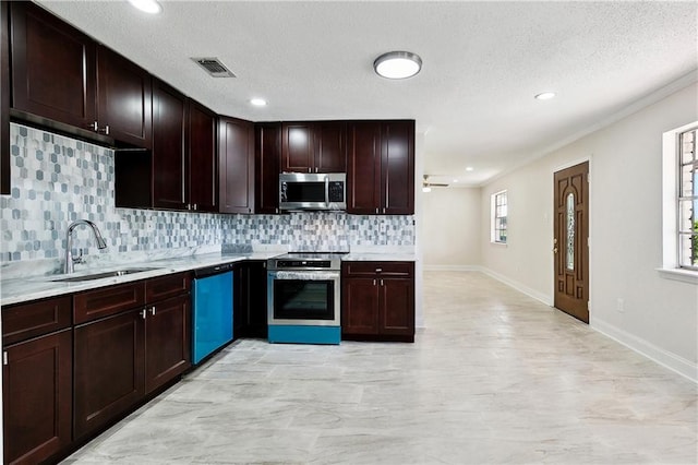 kitchen with visible vents, a sink, light countertops, and stainless steel appliances