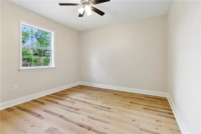empty room with baseboards, ceiling fan, and wood finished floors