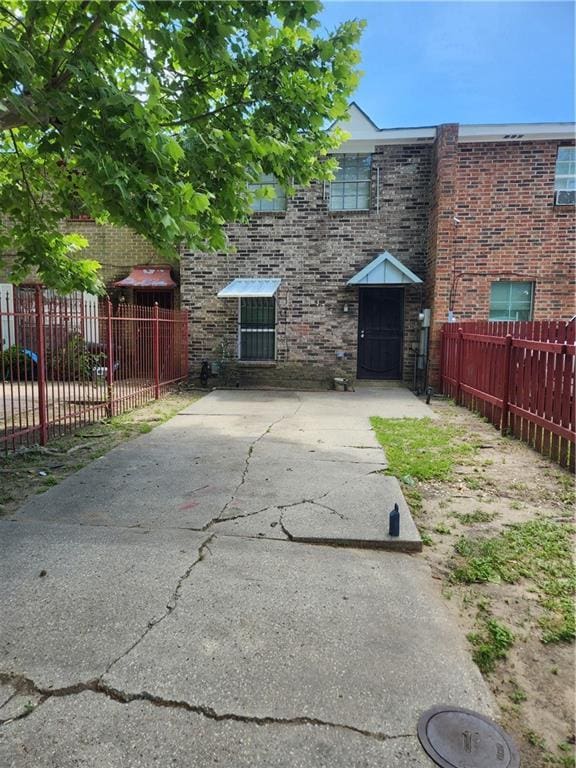 exterior space featuring fence private yard and brick siding