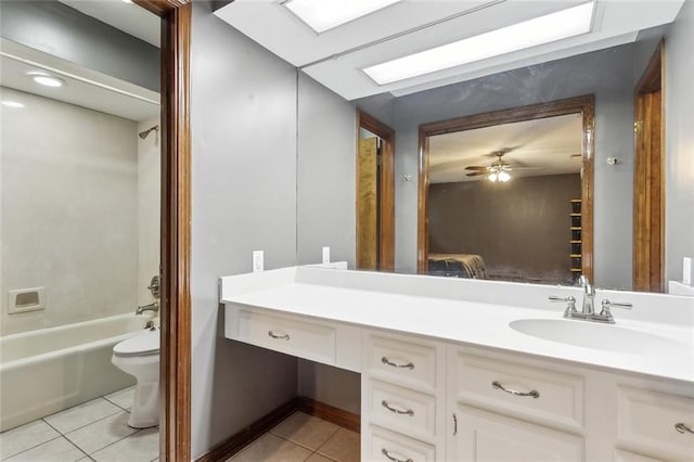 full bath featuring vanity, toilet, washtub / shower combination, ceiling fan, and tile patterned floors