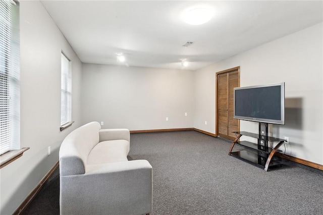 living area featuring baseboards, carpet floors, and visible vents