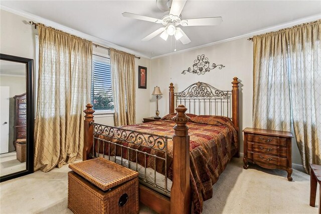 bedroom with a ceiling fan, ornamental molding, and carpet