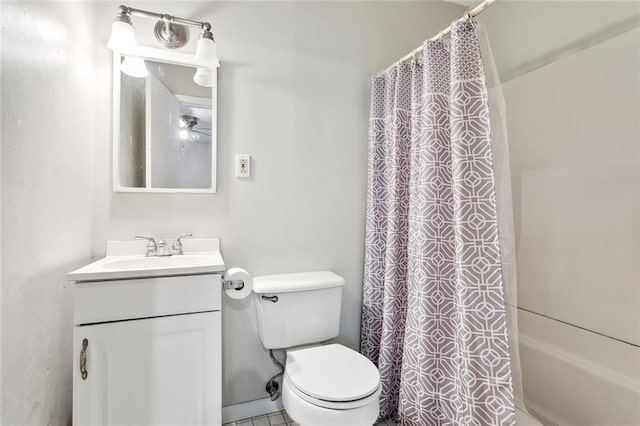 bathroom with vanity, a shower with shower curtain, and toilet