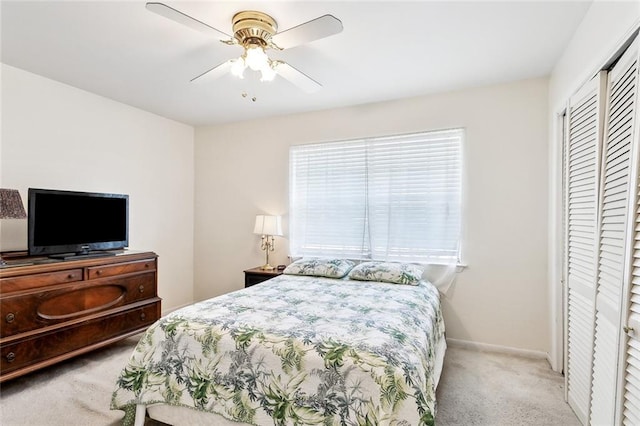 bedroom with carpet floors, baseboards, ceiling fan, and a closet