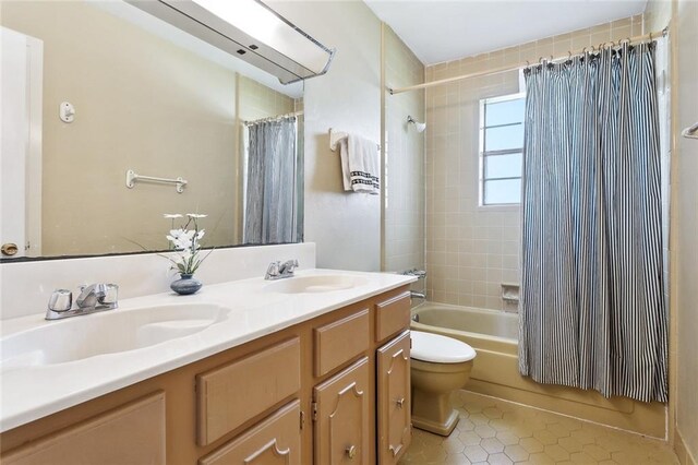 bathroom with a sink, tile patterned flooring, shower / bath combo, and toilet