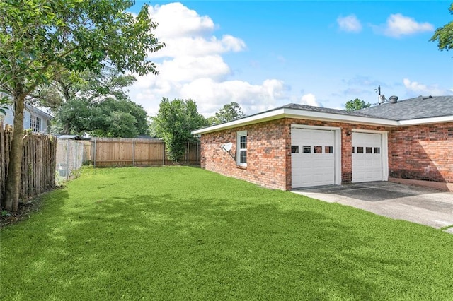 view of side of home featuring a yard, brick siding, driveway, and a garage
