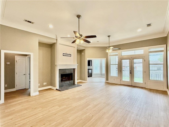 204 Doerr Dr, Arabi, LA 70032 - unfurnished living room featuring light wood-style flooring, a fireplace with raised hearth, a ceiling fan, ornamental molding, and baseboards