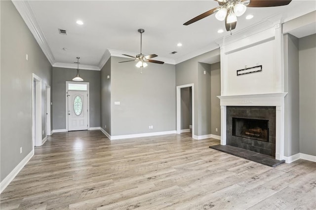 unfurnished living room with visible vents, a ceiling fan, light wood finished floors, and crown molding
